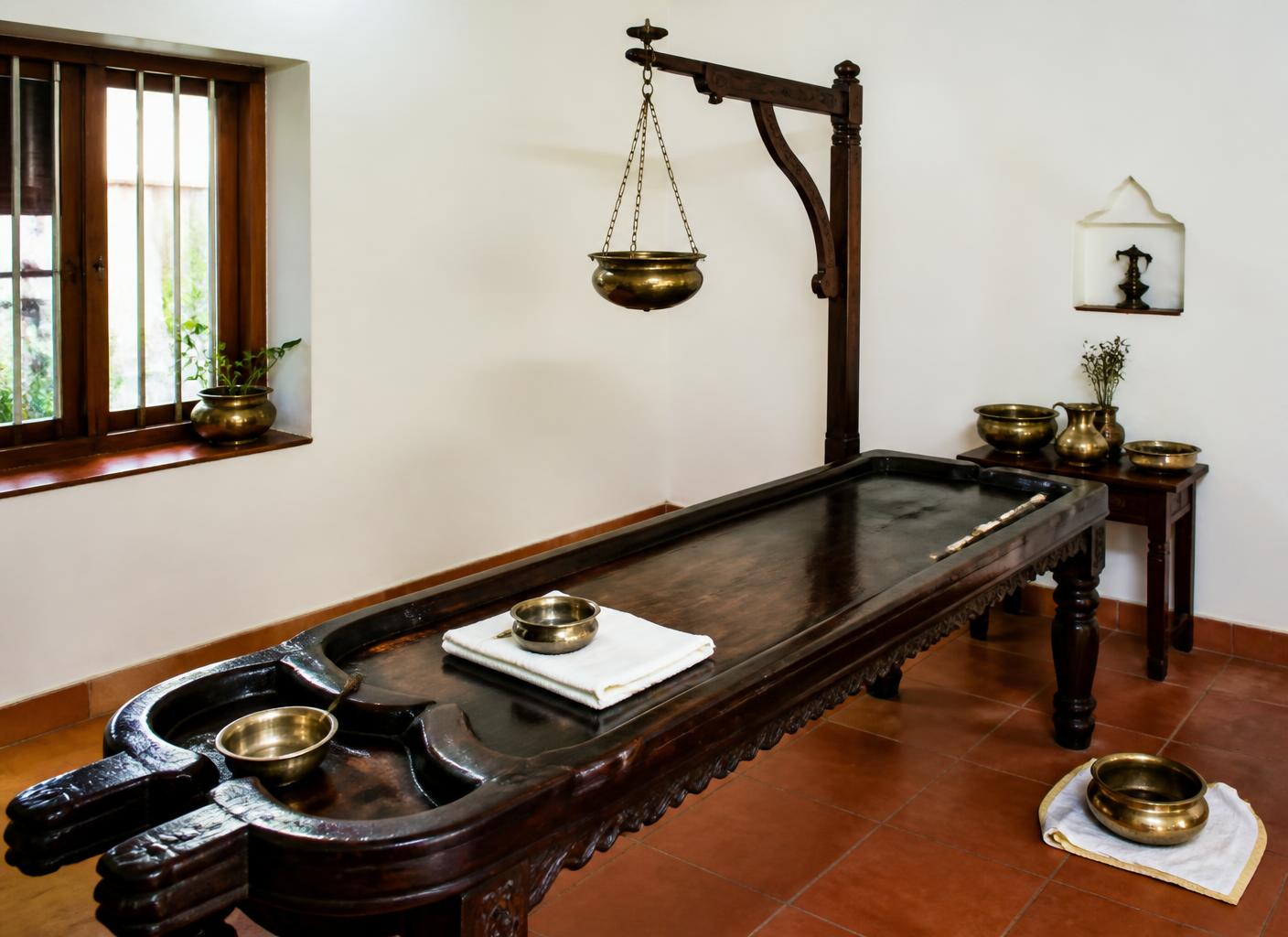 Authentic Kerala Ayurvedic treatment room with a traditional carved wooden droni table